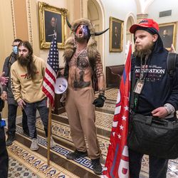 Supporters of President Donald Trump are confronted by Capitol Police officers outside of the Senate chamber inside the Capitol on Wednesday, Jan. 6, 2021 in Washington.
