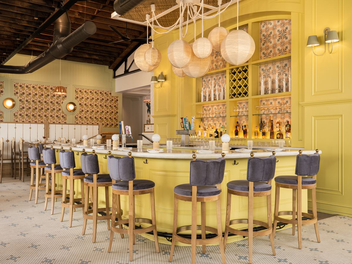 A yellow bar with purple stools. 