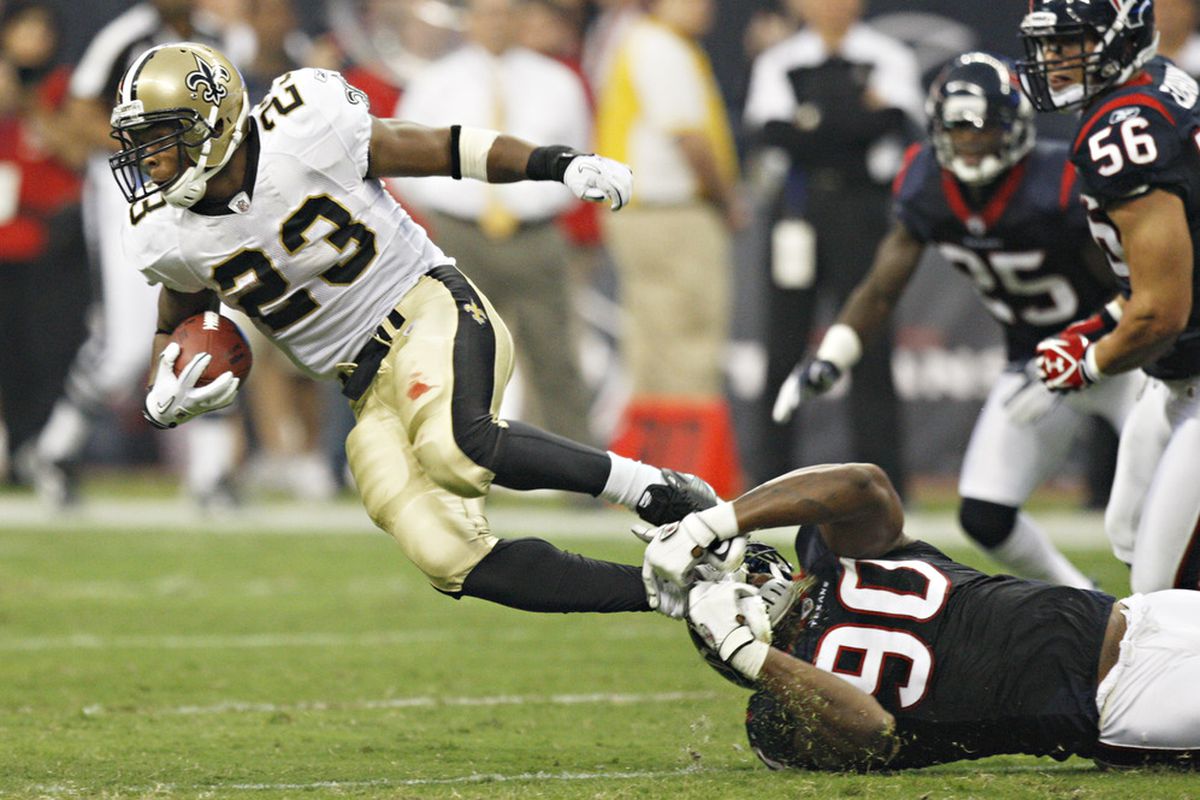 HOUSTON - AUGUST 20:  Running back Pierre Thomas #23 of the New Orleans Saints is tackled by linebacker Mario Williams #90 at Reliant Stadium on August 20, 2011 in Houston, Texas.  (Photo by Bob Levey/Getty Images)
