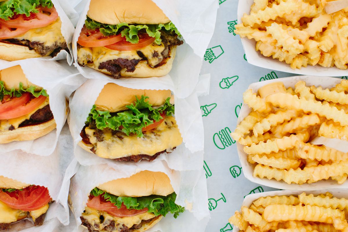 A full tray of burgers and crinkle-cut fries from Shake Shack, shown above.