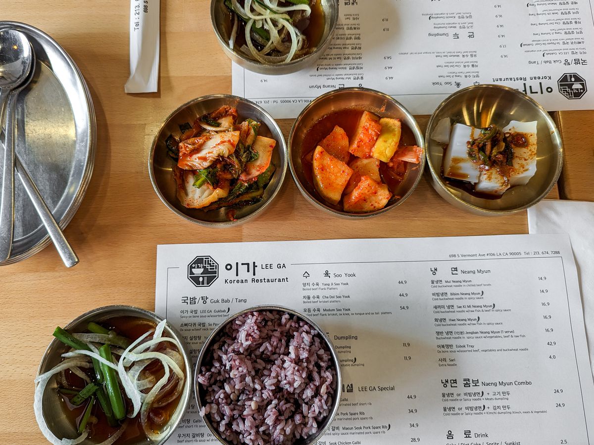 Banchan with mixed rice and dipping sauce with menu at LeeGa in Koreatown.