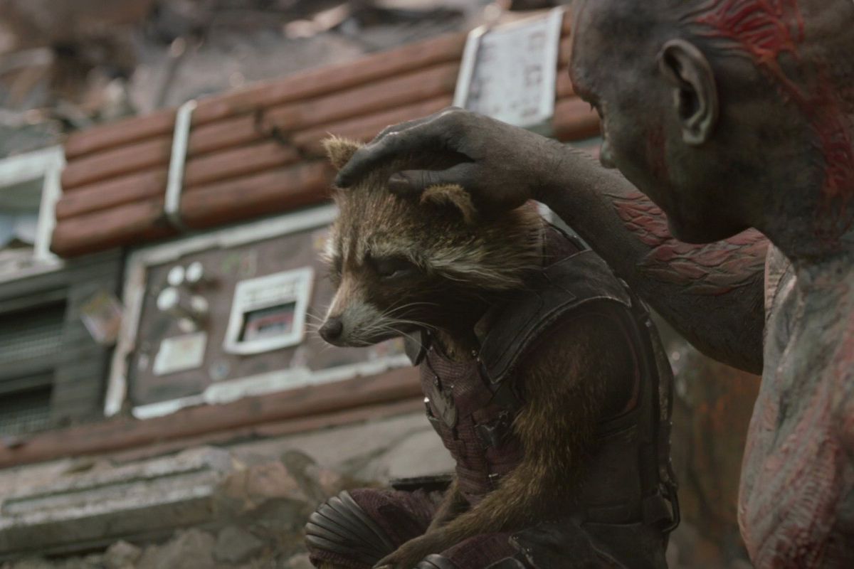 Drax pets a grieving Rockett Raccoon on the head in Guardians of the Galaxy Vol. 1. 