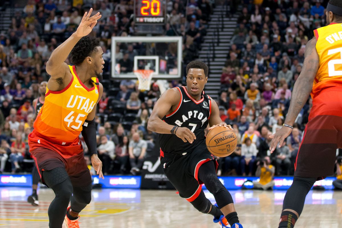 Toronto Raptors guard Kyle Lowry dribbles the ball as Utah Jazz guard Donovan Mitchell defends during the first quarter at Vivint Smart Home Arena.