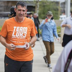 Texas men's tennis coach Michael Center walks with Defense lawyer Dan Cogdell away from the United States Federal Courthouse in Austin, Texas, Tuesday, March 12, 2019. Center is among a few people in the state charged in a scheme that involved wealthy parents bribing college coaches and others to gain admissions for their children at top schools, federal prosecutors said Tuesday. (Ricardo B. Brazziell