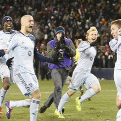 Sporting KC players swarm keeper Jimmy Nielsen as Sporting KC defeats Real Salt Lake Saturday, Dec. 7, 2013 in MLS Cup action.