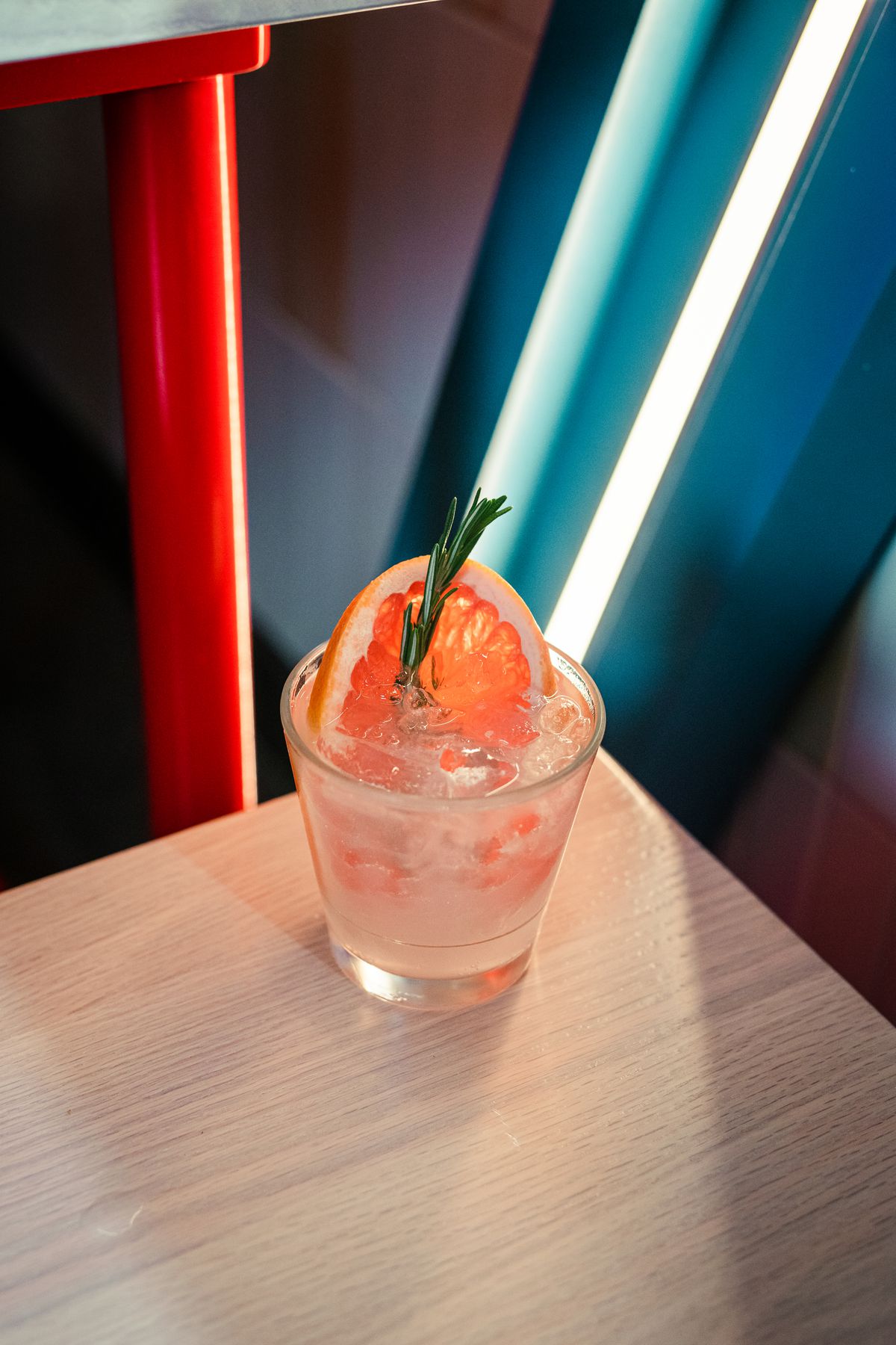 A cocktail in front of neon lights