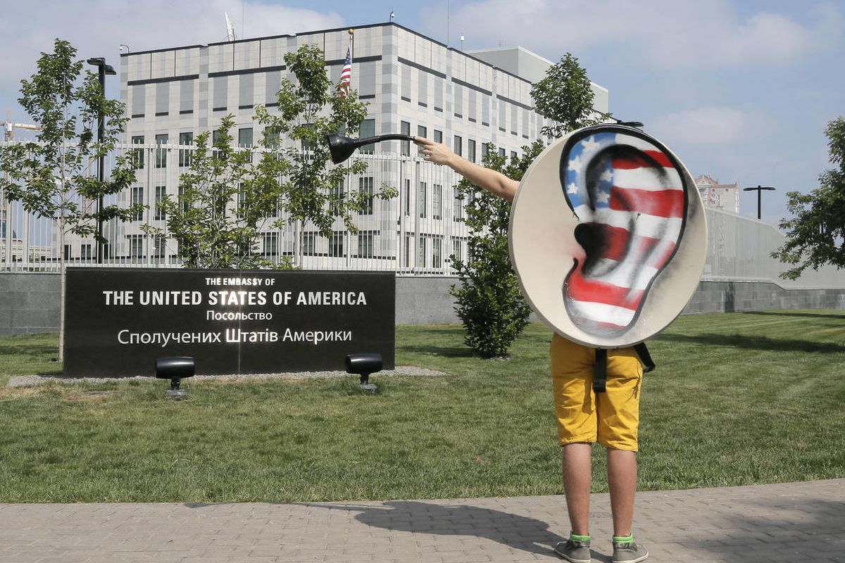An activist of Ukraine's Internet party gestures as he demands the American authorities stop  the pursuit of National Security Agency leaker Edward Snowden at an action of protest near the US Embassy in Kiev, Ukraine, Thursday, June 27, 2013. 
