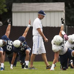 Head coach Bronco Mendenhall watches his players stretch during a BYU football practice at BYU's practice fields Thursday, Aug. 14, 2014.