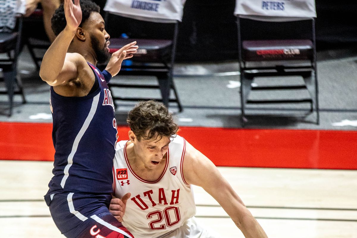 Utah Utes’ forward Mikael Jantuen (20) moves with the ball against Arizona Wildcats’ forward Jordan Brown (21) during a men’s basketball game at the Huntsman Center in Salt Lake City on Thursday, Feb. 4, 2021.