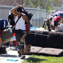 People move their belongings as the Salt Lake County Health Department cleans up a homeless camp on 500 West in Salt Lake City on Thursday, May 4, 2017.