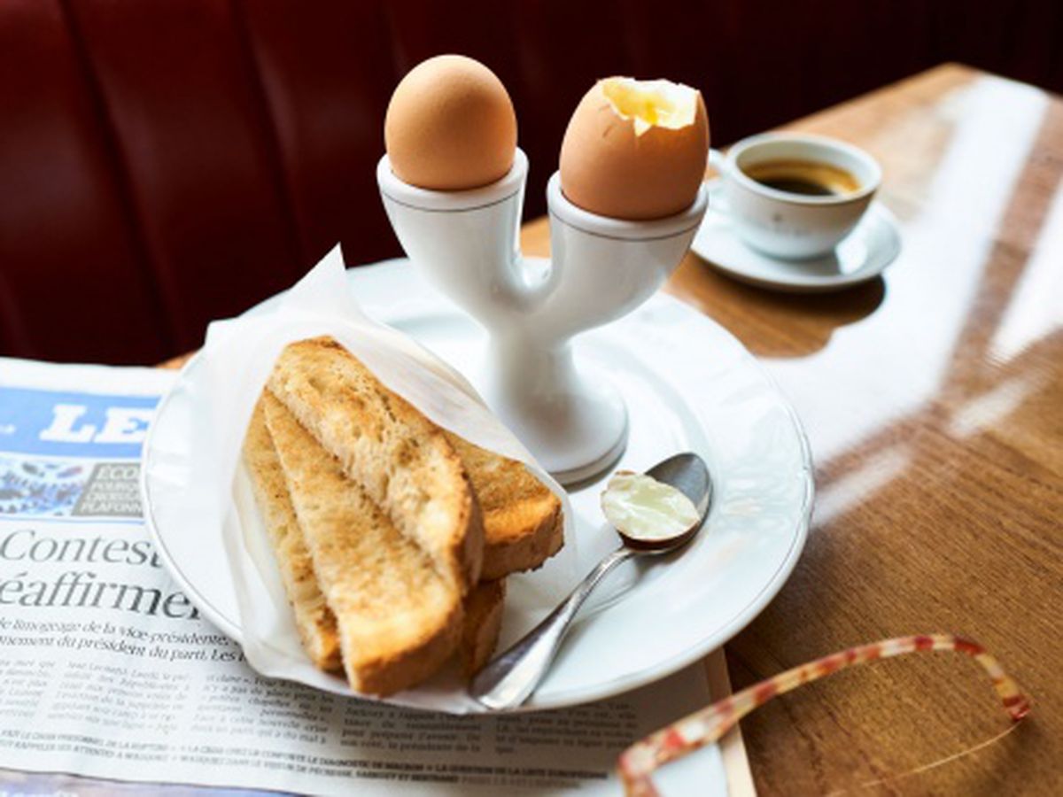 Eggs and soldiers with a newspaper at Colbert restaurant