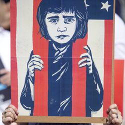 Samantha Joel holds a sign at a rally protesting the separation of immigrant children from their parents at the state Capitol in Salt Lake City on Saturday, June 30, 2018.