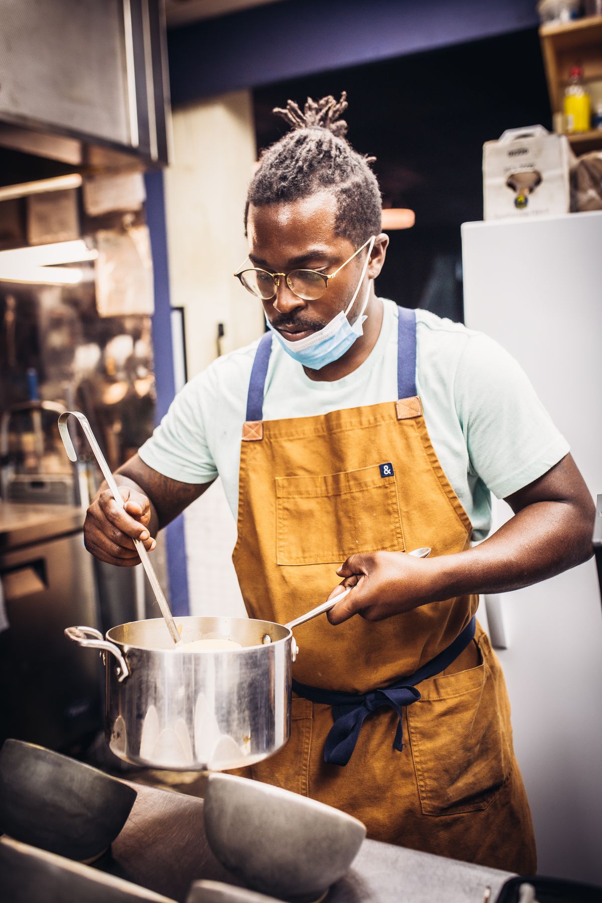 Chef Jonny Rhodes, stirring a pot.  