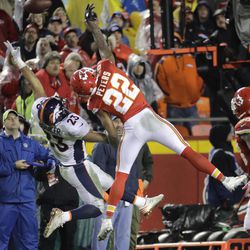 Kansas City Chiefs defensive back Marcus Peters (22) and Denver Broncos running back Devontae Booker (23) can't reach a pass during the second half of an NFL football game in Kansas City, Mo., Sunday, Dec. 25, 2016. 