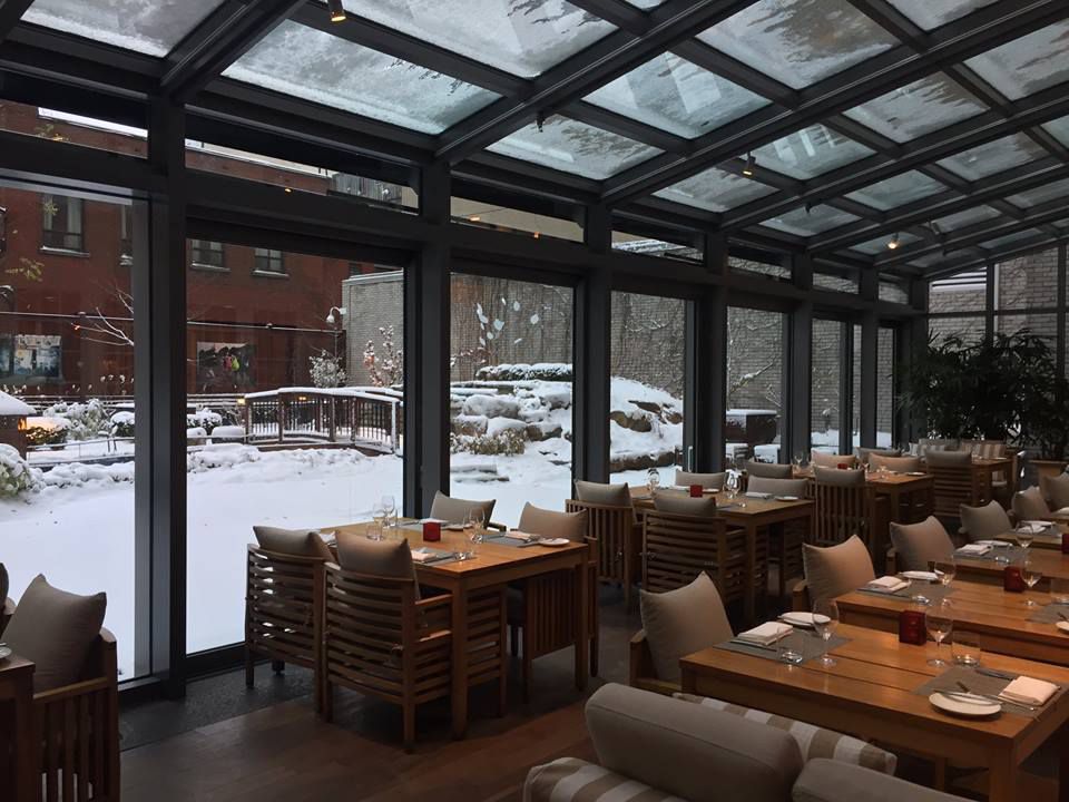 A patio with a view of snow outside.