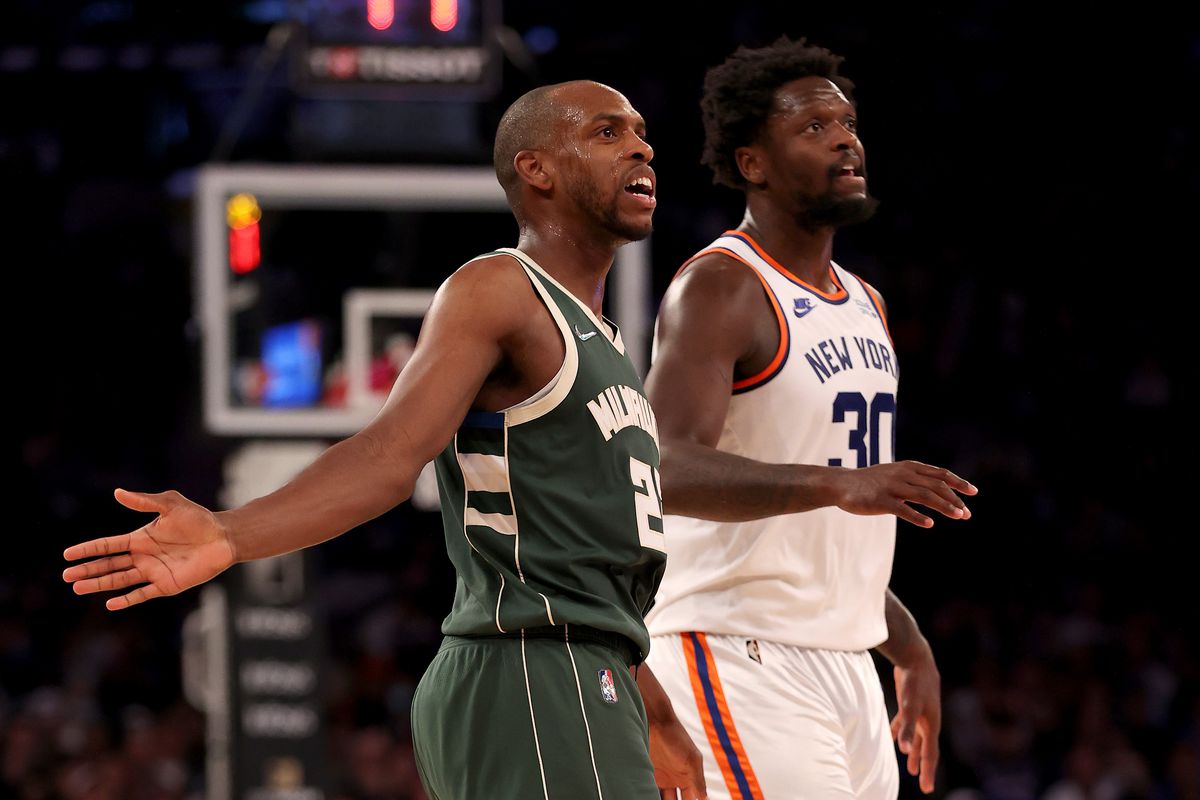 Khris Middleton #22 of the Milwaukee Bucks reacts after he shoots a three as Julius Randle #30 of the New York Knicks defends in the second half at Madison Square Garden on December 12, 2021 in New York City. The Milwaukee Bucks defeated the New York Knicks 112-97.