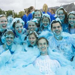 Students soaked in blue foam stop to snap a photo during BYU's homecoming week.