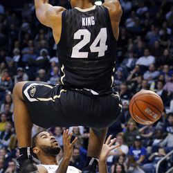 Colorado Buffaloes guard George King (24) dunks the ball with Brigham Young Cougars guard L.J. Rose (5) below during an NCAA basketball game in Provo on Saturday, Dec. 10, 2016.