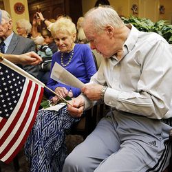 Veteran Brent Uibel and Mildred Henry, wife of a veteran, receive flags during a ceremony honoring veterans at Highland Glen Senior Living Center and Memory Care in Highland on Wednesday, Nov. 9, 2016.
