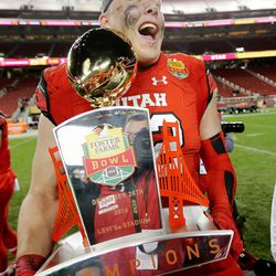 Utah Utes offensive lineman Garett Bolles (72) carries the Foster Farms champions trophy out to his teammates after the Utes defeated the Indiana Hoosiers in Santa Clara, California, on Wednesday, Dec. 28, 2016.