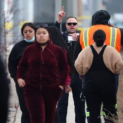 People gather near the scene as police investigate a fatal shootings in West Valley City, near Hunter High School along 4100 South at Mountain View Corridor, on Thursday, Jan. 13, 2022.