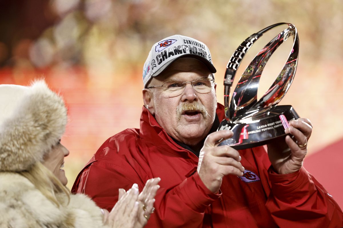 KANSAS CITY, MISSOURI - JANUARY 29: Kansas City Chiefs head coach Andy Reid celebrates with the Lamar Hunt Trophy after winning the AFC Championship NFL football game between the Kansas City Chiefs and the Cincinnati Bengals at GEHA Field at Arrowhead Stadium on January 29, 2023 in Kansas City, Missouri.