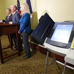 Lt. Gov. Spencer Cox, center, is joined by Davis County Clerk Curtis Koch, left, and Salt Lake County Clerk Sherrie Swensen as the elections office releases updated voter statistics on Tuesday, Nov. 1, 2016.