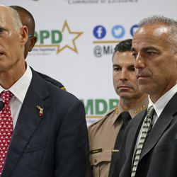 FILE- In this Feb. 27, 2018 file photo, Florida Gov. Rick Scott talks alongside Andrew Pollack, right, whose daughter Meadow was murdered in Parkland during press conference at Miami-Dade Police Department in Doral, Fla. The mass shooting at Marjory Stoneman Douglas High School has put guns at the forefront, for now, in the U.S. Senate campaign in Florida. Republican Gov. Rick Scott, is expected to mount a campaign to oust incumbent Democrat U.S. Bill Nelson from his Senate. (C.M. Guerrero/Miami Herald via AP, File)