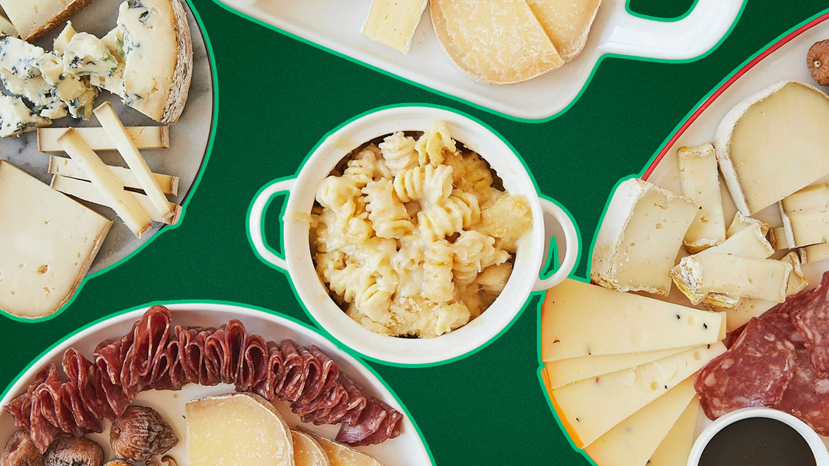 A selection of cheeses and mac and cheese on plates against a green backdrop