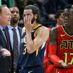 Utah Jazz guard Ricky Rubio (3) holds his eye as Atlanta Hawks head coach Mike Budenholzer and guard Dennis Schroder (17) dispute a flagrant foul call at Vivint Smart Home Arena in Salt Lake City on Tuesday, March 20, 2018.