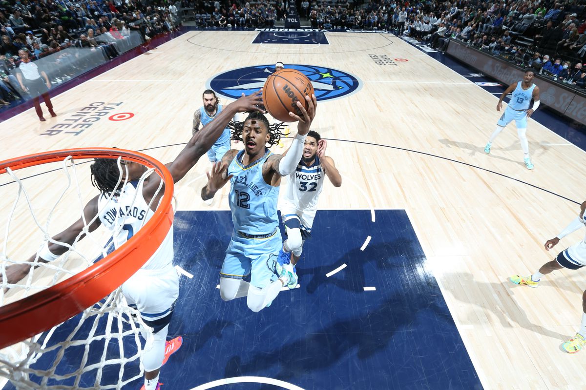 Ja Morant #12 of the Memphis Grizzlies drives to the basket during the game against the Minnesota Timberwolves on February 24, 2022 at Target Center in Minneapolis, Minnesota.&nbsp;