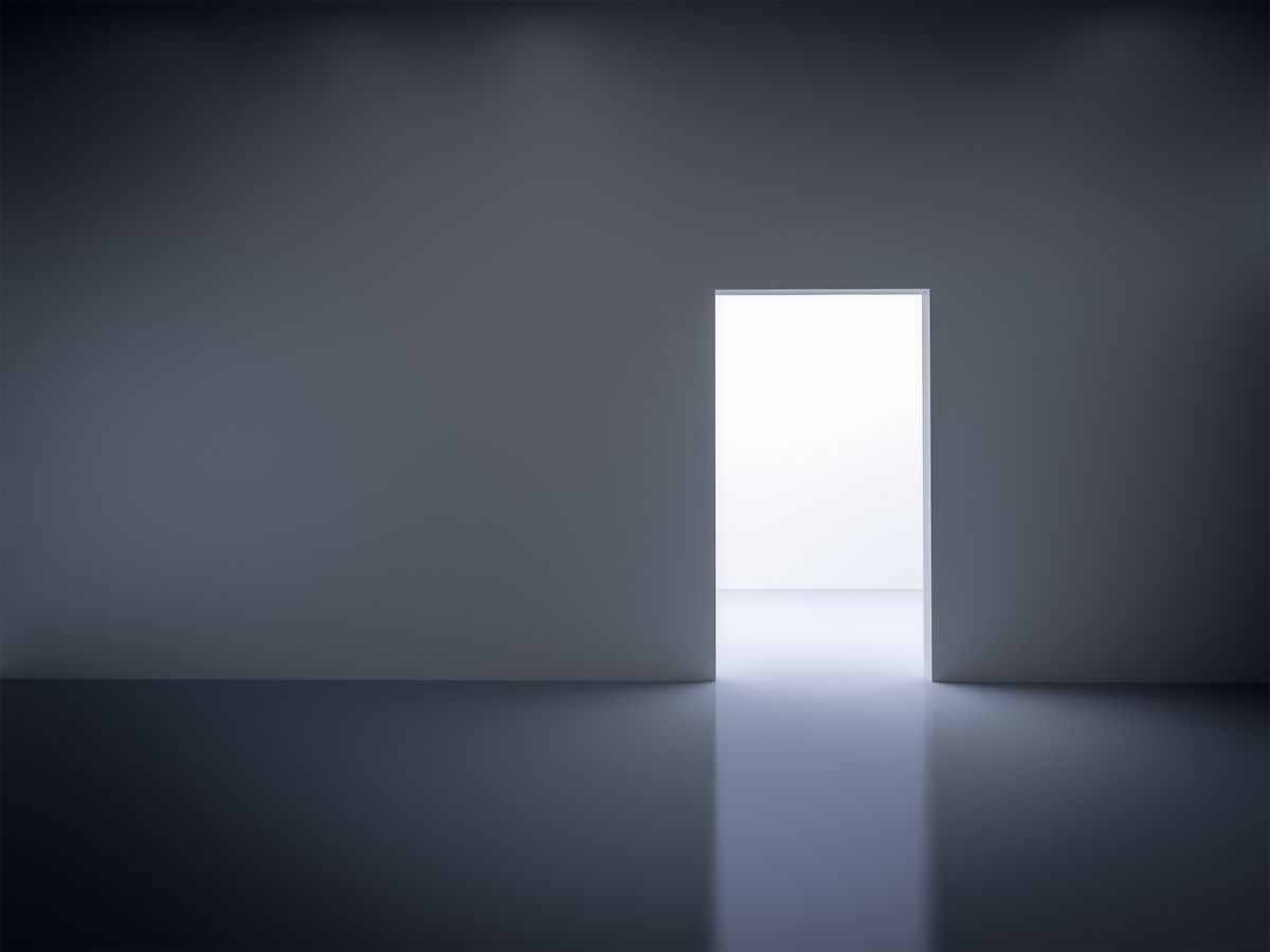 An open door in a blank room