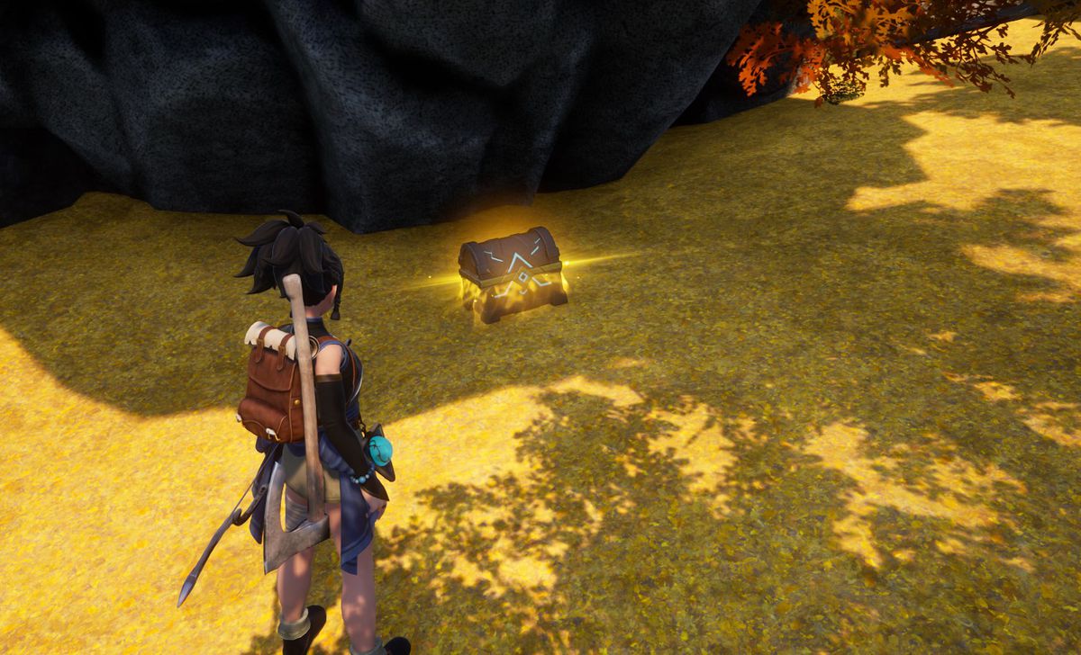 A Palworld characters stands in front of a gold glowing chest