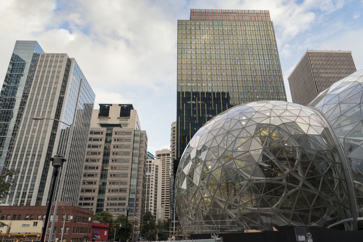 A view of Amazon’s downtown campus on a cloudy day, with a main office building and the Spheres shown at the right