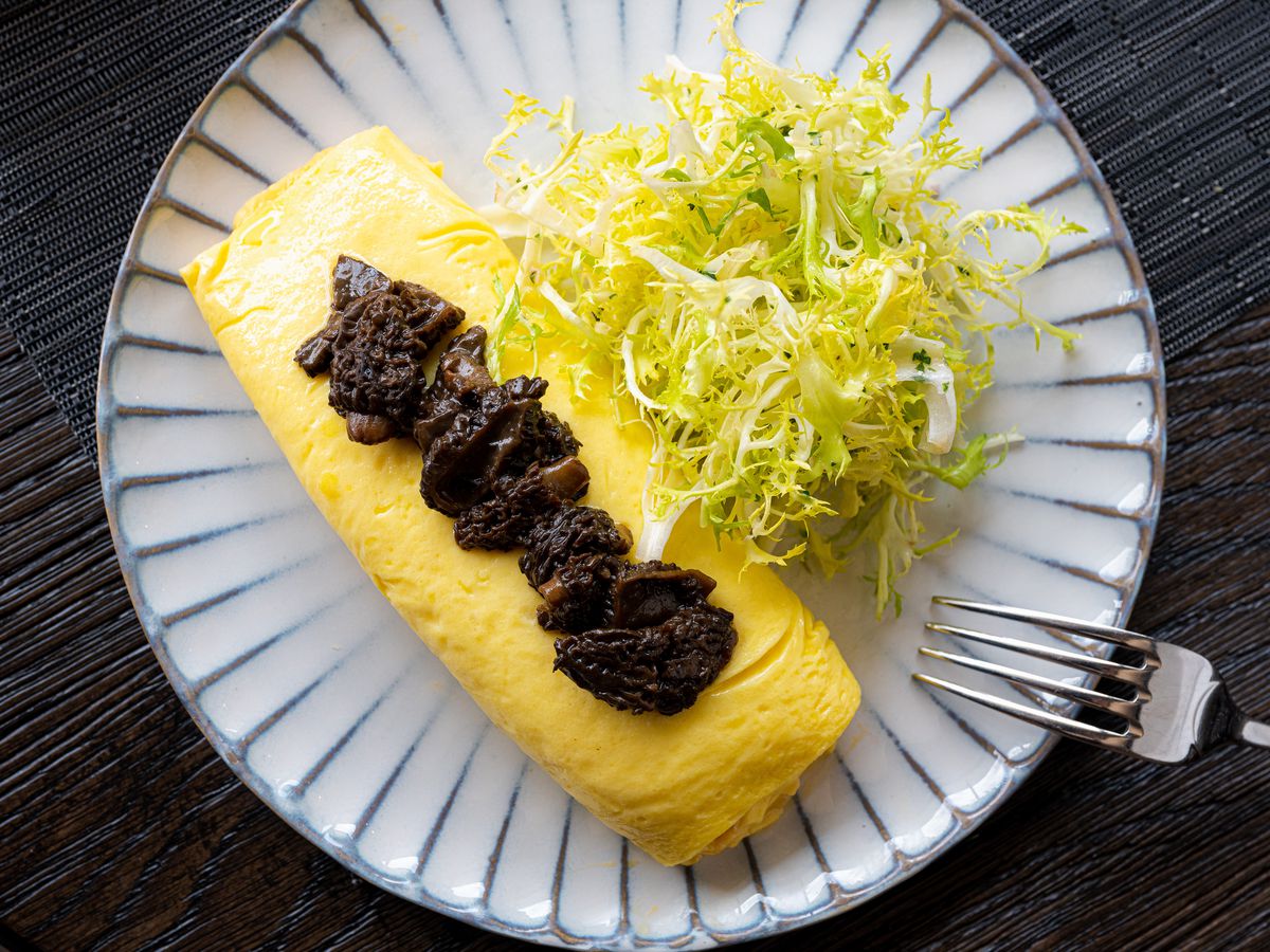 Omelet stuffed with raclette and plated with frisée at Navy Blue.