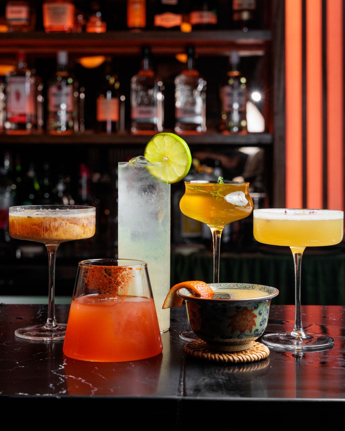 A collection of cocktails on a bar.
