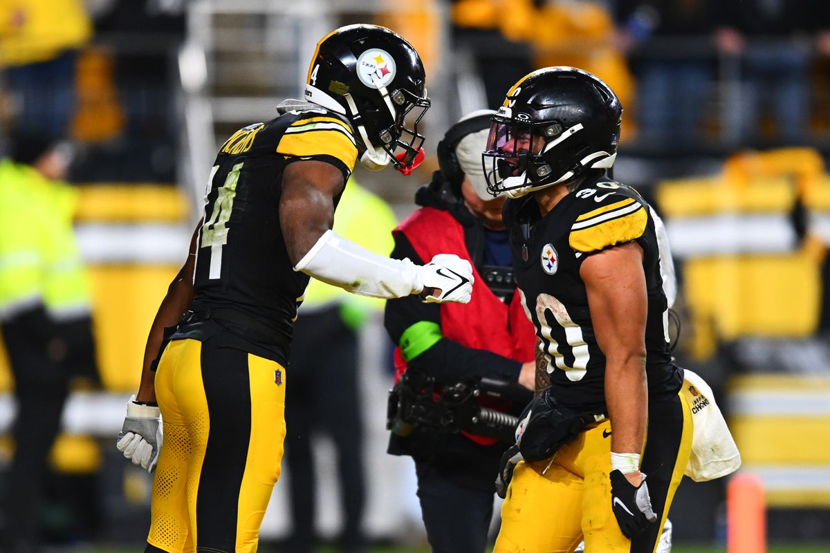 George Pickens #14 of the Pittsburgh Steelers celebrates after scoring a touchdown with his teammate Jaylen Warren #30 during the third quarter of a game against the Cincinnati Bengals at Acrisure Stadium on December 23, 2023 in Pittsburgh, Pennsylvania.