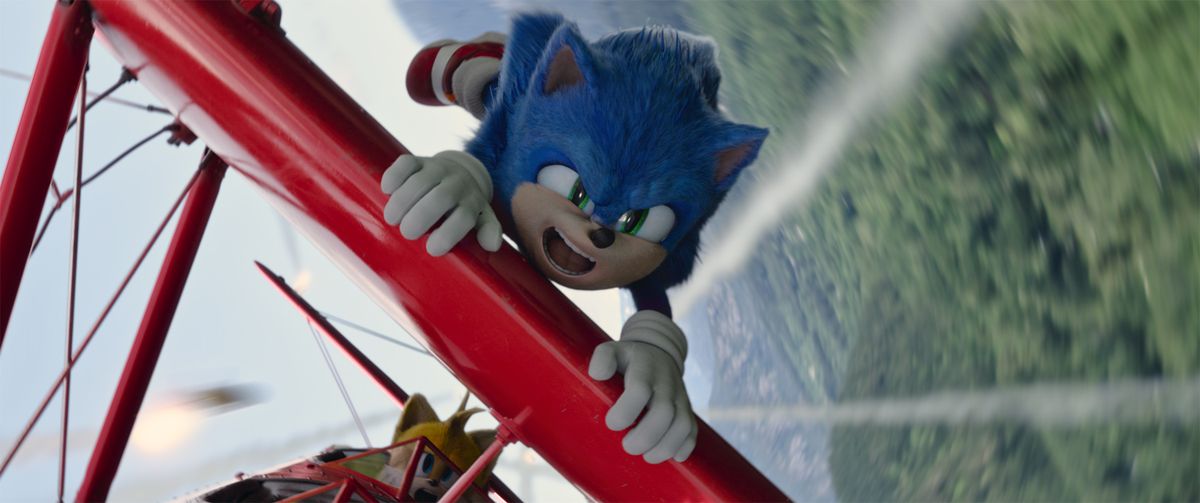 Sonic holds on to a plane driven by Tails in Sonic the Hedgehog 2