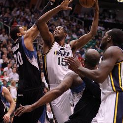 Derrick Favors of the Utah Jazz takes a shot with Chris Johnson of the Minnesota Timberwolves defending during NBA basketball in Salt Lake City Friday, April 12, 2013.