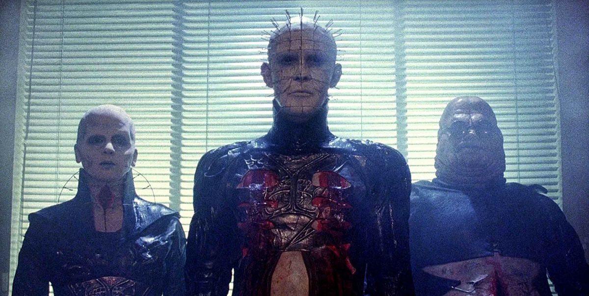 Pinhead flanked by two other cenobites in Hellraiser (1987)