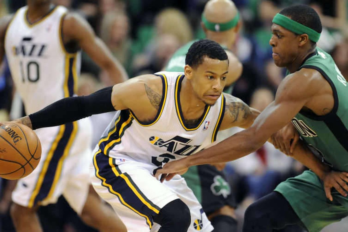 Utah Jazz point guard Trey Burke (3) keeps the ball out of the reach of Boston Celtics point guard Rajon Rondo (9) during a game at EnergySolutions Arena on Monday, Feb. 24, 2014.