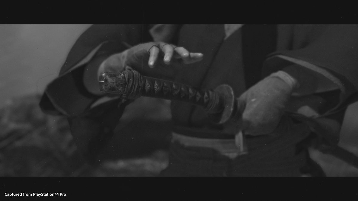 A black and white screenshot of a samurai about to unsheathe his sword from Ghost of Tsushima.