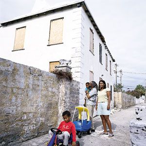 <p>Homeowners Delaey Robinson and Andrea Dismont in front of Harbour View before construction, with their sons, Kelsey (foreground) and Myles.</p>