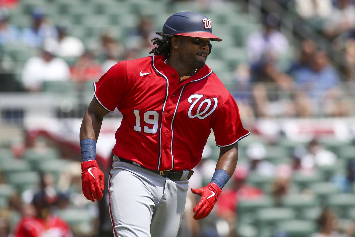 Washington Nationals first baseman Josh Bell (19) hits a double against the Atlanta Braves in the fourth inning at Truist Park.