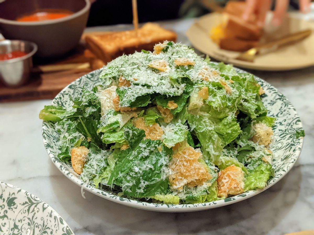 Caesar salad from Cafe Fig inside the Hotel Figueroa in a speckled plate.