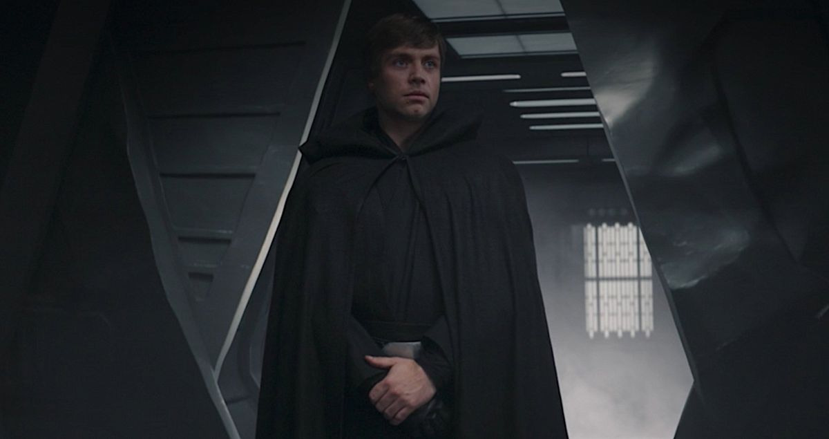 Deepfake Luke Skywalker from The Mandalorian, standing in a doorway with his hands folded