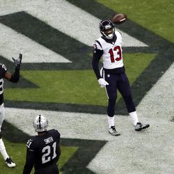 Houston Texans wide receiver Braxton Miller (13) celebrates after scoring a touchdown as Oakland Raiders cornerback David Amerson (29) and teammate cornerback Sean Smith (21) react during the first half of an NFL football game Monday, Nov. 21, 2016, in Mexico City. 