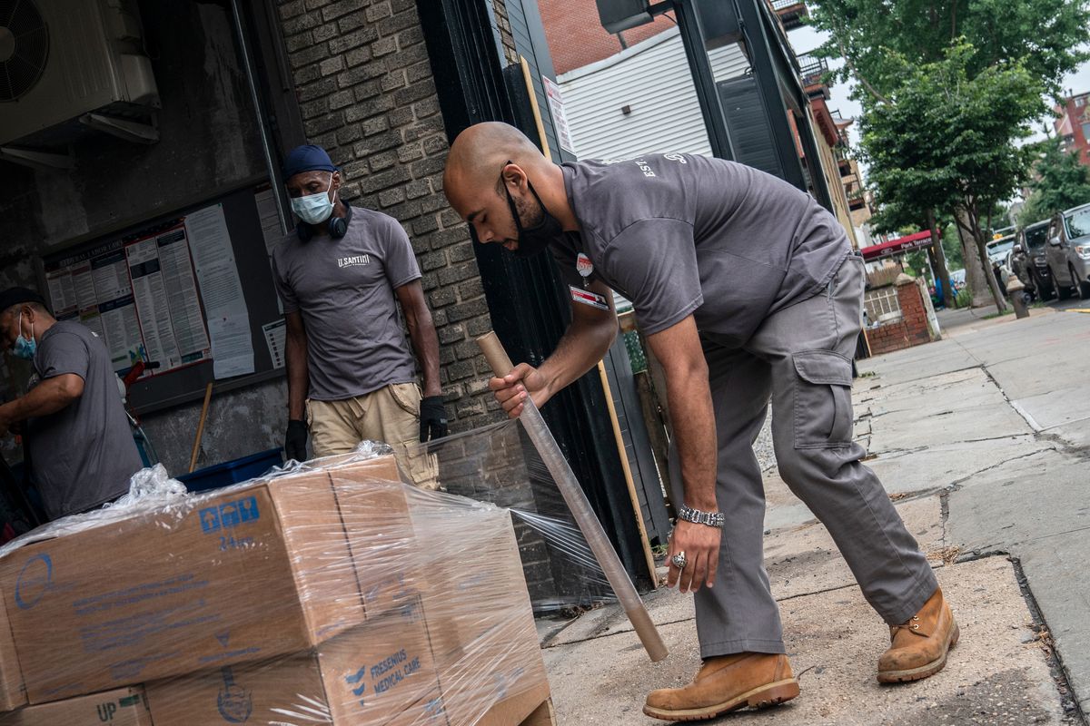 Santini Moving &amp; Storage employees wrap boxes at their Park Slope warehouse, July 24, 2020.