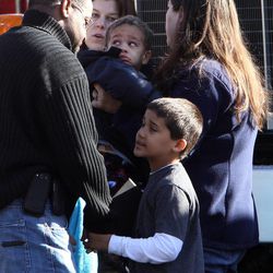 Schoolchildren wait for their parents at the Sandy Hook firehouse following a mass shooting at Sandy Hook Elementary School, Friday, Dec. 14, 2012 in Newtown, Conn.  