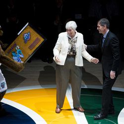 Gail Miller presents former player John Stockton with a plaque during a halftime ceremony celebrating the 1997 Utah Jazz at Vivint Smart Home Arena in Salt Lake City on Wednesday, March 22, 2017.